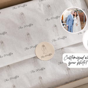 Pode incluir: Uma caixa de papelão branca contendo papel de seda personalizado impresso com um desenho de linha repetitivo de um casal e o texto The Kraffts. Um adesivo redondo com a mesma ilustração e texto veda o papel. Inclui uma foto e gráfico.