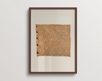 May include: A framed wall art piece featuring a square textile with a tan background and intricate dark brown geometric patterns. The design consists of repeating angular lines and shapes, with a vertical row of dark triangles along the left edge.