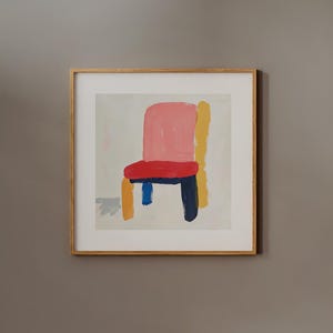 May include: A framed painting of a colorful chair with a pink seat, yellow back, blue legs, and a dark blue base. The chair is painted in a simple, abstract style against a white background.