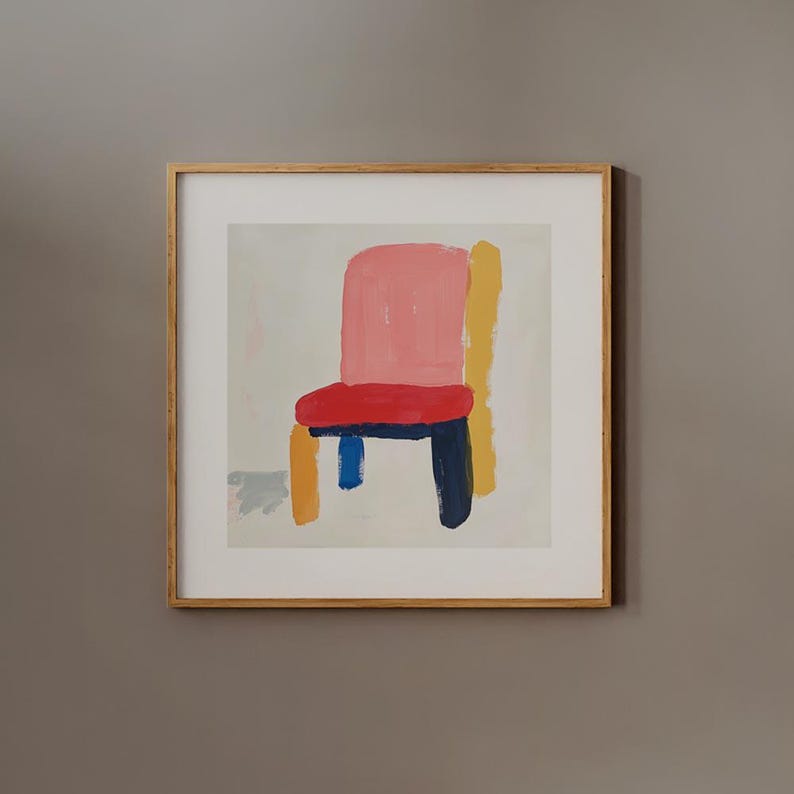 May include: A framed painting of a colorful chair with a pink seat, yellow back, blue legs, and a dark blue base. The chair is painted in a simple, abstract style against a white background.
