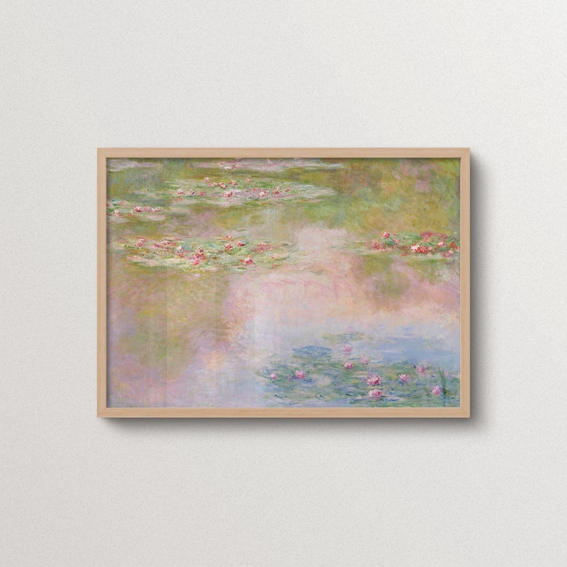 Monet Water Lilies impressionist wall art in a natural oak frame, with floating pink flowers and soft green, blush and blue reflections across a peaceful pond. Pastel floral landscape print for bedroom, living room, cottage-inspired and eclectic home decor.