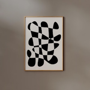 May include: Abstract art print with a black and white checkered pattern with rounded edges. The artwork is in a gold-coloured frame, displayed on a neutral wall. The design is a modern, minimalist style, suitable for various interior settings.