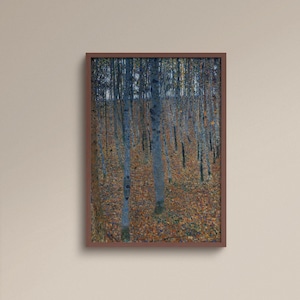 May include: A framed print of a forest scene. Tall, slender trees with blue-gray trunks stand amidst a bed of fallen brown leaves. The artwork is enclosed in a dark brown wooden frame, creating a natural and serene aesthetic.