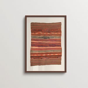 May include: A rectangular textile wall hanging displayed in a dark brown frame. The fabric features horizontal stripes in shades of orange, black, dark blue, and tan, with repeating geometric patterns of small triangles and wavy lines throughout.