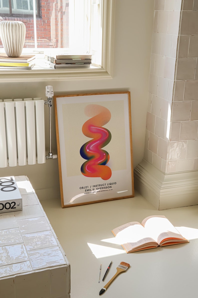 May include: A framed poster with a colorful abstract design of a swirling, liquid-like shape in shades of orange, pink, and blue. The poster is titled "OBJ21 / INSTRUCT LIQUID EMIL U. SVERISSON".