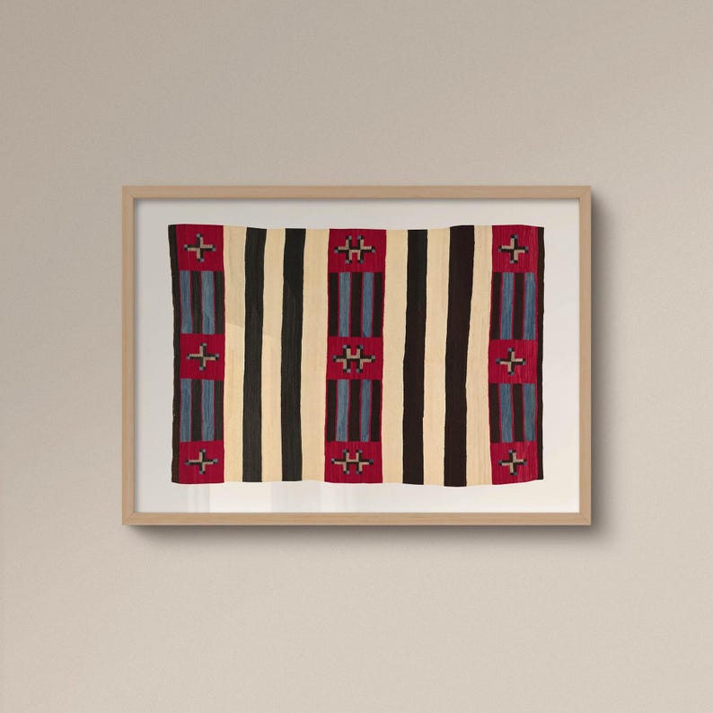 May include: A framed textile with a striped pattern. Alternating vertical stripes of black, cream, and red. The red stripes feature a cross-like design in the center. The textile is displayed in a light-colored wooden frame.