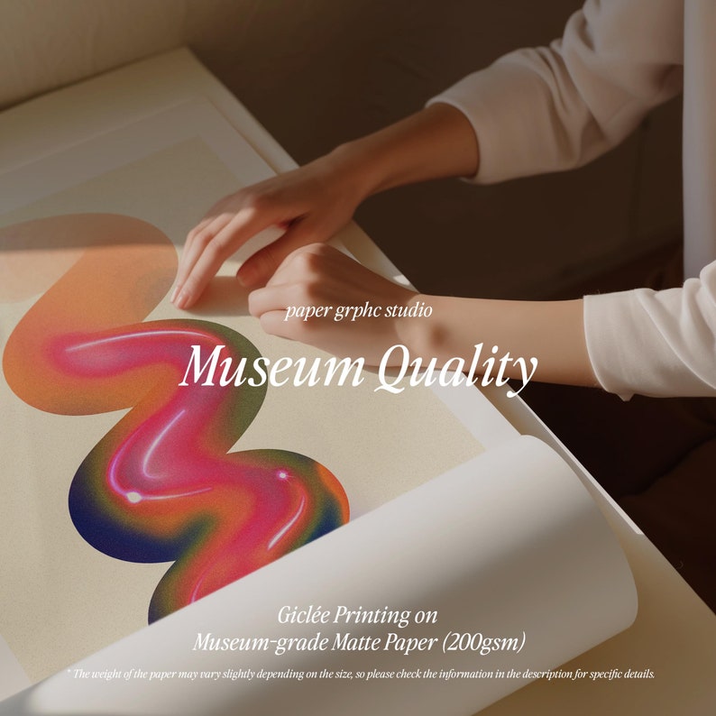 May include: A hand holding a print with a colorful abstract design. The print is on museum-grade matte paper and says "paper grphc studio Museum Quality Gicl&eacute;e Printing on Museum-grade Matte Paper (200gsm)".