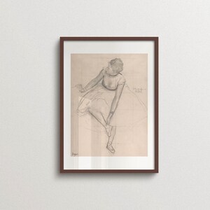 Vintage Edgar Degas ballerina sketch print in a walnut wood frame featuring a graceful seated dancer in soft graphite lines. Classic ballet wall art inspired by French Impressionism, ideal for gallery walls, Parisian interiors, wabi sabi, Japandi, Scandinavian, and timeless home decor.