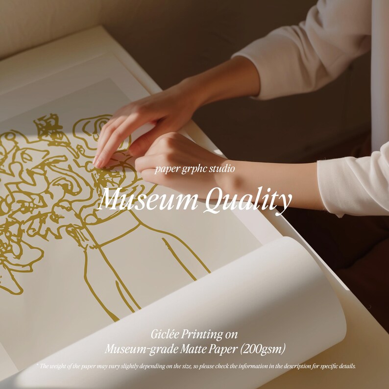 May include: A close-up of a hand holding a white sheet of paper with a gold line drawing of a vase of flowers. The paper is labeled "Museum Quality" and "Gicl&eacute;e Printing on Museum-grade Matte Paper (200gsm)".