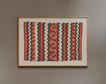 May include: A framed textile with a geometric pattern. The design features vertical stripes of red, black, white, and gold. The textile is displayed in a gold-colored frame, creating a decorative wall hanging.