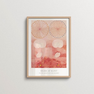 May include: A framed art print featuring Hilma af Klint's The Ten Largest, No. 9, Old Age (1907). The artwork displays abstract circular patterns, soft pink and peach watercolour tones, and geometric shapes. The text reads Hilma af Klint, The Ten Largest, No. 9, Old Age (1907) at the bottom.