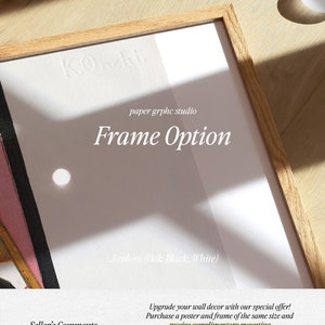 May include: A framed poster with the text "K.Oncht paper grphc studio Frame Option 3 colours (Oak, Black, White)". The poster is in a wooden frame with a light wood finish. The poster is on a light wood surface.