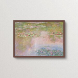 Claude Monet Water Lilies art print in a walnut frame, featuring a dreamy impressionist pond landscape with soft pink, green, blue and lavender tones. Pastel landscape wall art for living room, bedroom, reading nook or romantic vintage-inspired interiors.