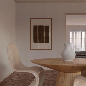 Framed brown checker pattern textile print styled above a wooden dining table in a neutral organic modern dining room with Japandi decor.