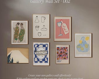 May include: A gallery wall set with nine framed prints. The prints feature a variety of abstract and illustrative designs, including a mountain, fish, a wine glass, and a shopping bag. The prints are all in different colors and styles, and they are arranged in a grid pattern on a light brown wall.