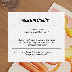 Puede incluir: Impresi&oacute;n con el texto "Museum Quality" e informaci&oacute;n sobre papel de bellas artes, propiedades de archivo y tintas libres de &aacute;cido. La impresi&oacute;n tiene un fondo claro con formas abstractas naranjas y amarillas.