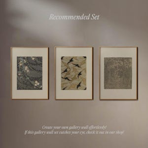 Curated gallery wall of three vintage-inspired art prints displayed in warm wood frames against a softly shadowed taupe wall. Combining delicate floral motifs, an earthy botanical pattern and an antique woodland illustration, this neutral art trio offers an elegant gallery wall arrangement for vintage eclectic homes, transitional interiors and collected-style living spaces.