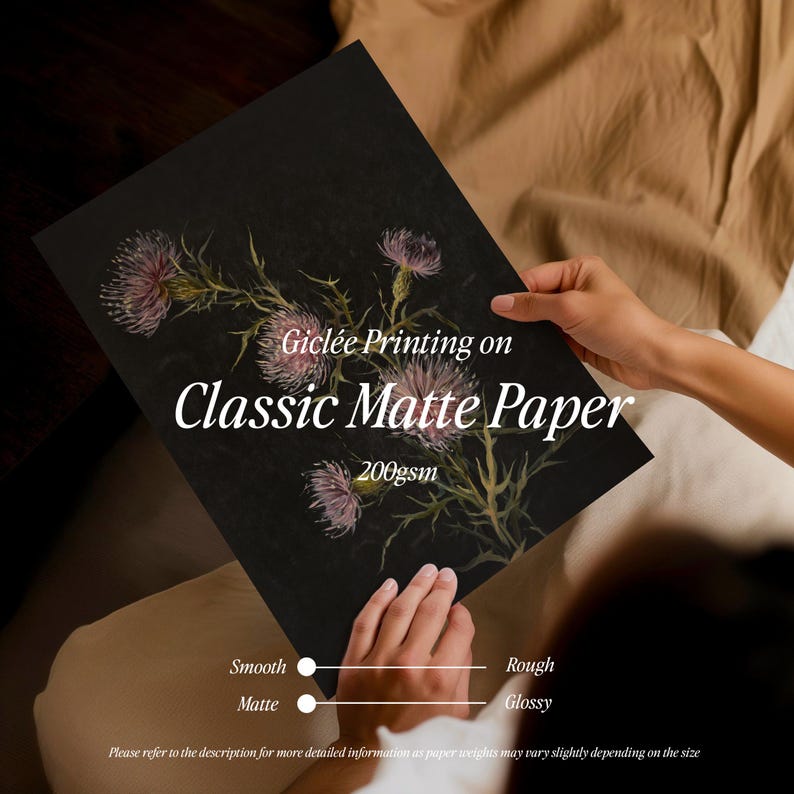 May include: A close-up of a black card with a floral illustration and the text "Gicl&eacute;e Printing on Classic Matte Paper 200gsm". The card is being held by a person's hand. Below the text are two sliders labeled "Smooth Matte" and "Rough Glossy".