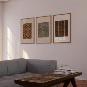 Earth tone textile wall art set in a calm wabi sabi inspired living room with natural materials and vintage decorative patterns