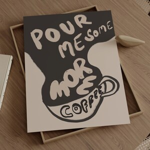 May include: A black and white illustration of a coffee cup with the text "Pour me some more coffee" in a stylized font.