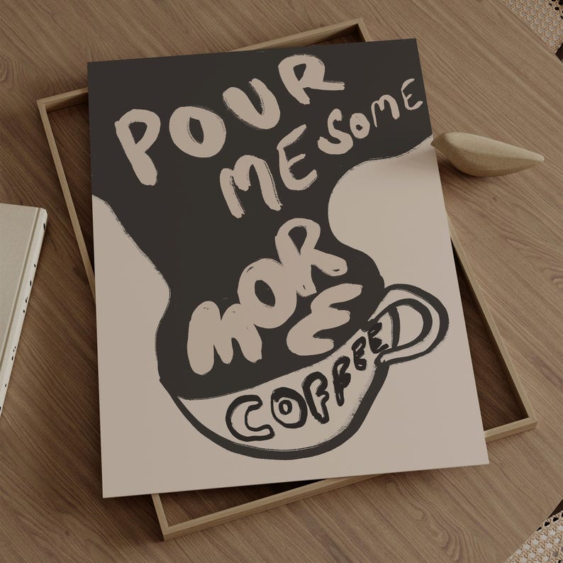 May include: A black and white illustration of a coffee cup with the text "Pour me some more coffee" in a stylized font.