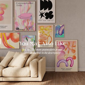 May include: A living room interior with a beige sofa and several colorful abstract art prints on the wall. The prints feature geometric shapes and gradients in pink, purple, orange, and yellow. The text on the prints reads "{UnderwaterGarden} Goldie", "20 Gallery 水族", "METALLIC/SOLID LIQUID EMIL U. SVERISSON", and "You May Also Like You can find more postmodern prints through the link in the description!"