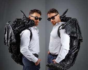 Leather dragon-backpack hugging you,  dragon tail wraps its around your waist, puts its paws on shoulders, covers your shoulders with wings