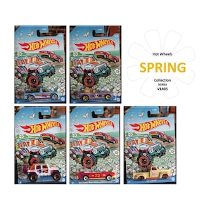 May include: A collection of Hot Wheels Spring Collection toy cars on display. The packaging features a floral design with the Hot Wheels logo. The cars are various colors, including blue, purple, red, and yellow. The text "Hot Wheels Spring Collection" is visible.