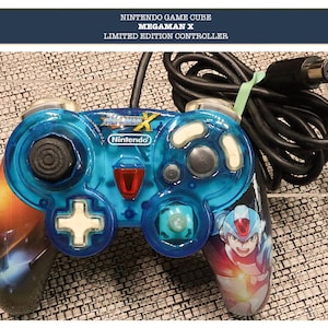 May include: A limited edition Nintendo GameCube controller. The controller is transparent blue with a black cable and features the text "MEGAMAN X" and "Nintendo". The controller has a colorful graphic of a character on the right side.