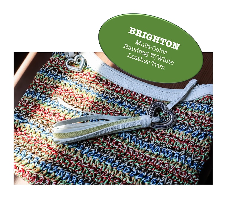 May include: Multi-color crochet handbag with white leather trim and a heart-shaped metal clasp. Brighton.