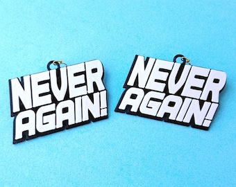 May include: A pair of black and white earrings with the text "NEVER AGAIN!" on each earring.