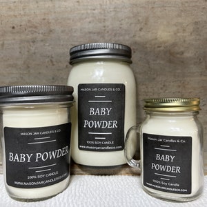 May include: Three mason jar candles with metal lids. Each jar has a black label with the text "BABY POWDER" and "100% SOY CANDLE". The jars are filled with a creamy white wax. The smallest jar has a handle.