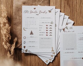 May include: A set of printable baby memory cards with a neutral color palette and illustrations of animals, a tent, a moon, and a clock. The cards include prompts such as "First Words", "First Smile", and "First Steps".