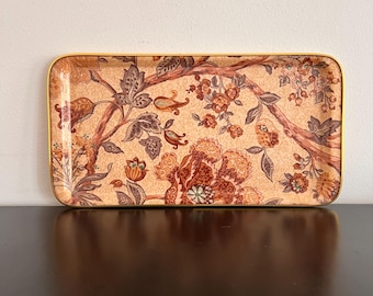 May include: A rectangular serving tray with a gold trim and a floral pattern in shades of brown, red, and cream.