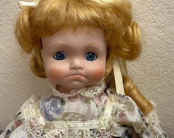 Bradley Porcelain Doll 13", Blonde Curls, Blue Eyes, Pouty Face, Floral Dress, Missing Hand, Shoe, and Sock