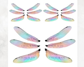 May include: A white sheet featuring multiple sets of iridescent dragonfly wings. The wings are in various sizes and orientations, with delicate veining details. The sheet includes text that reads "Dragonflies No. 156" and "Cecil & Co Fairy Wings Dragonfly Collection."