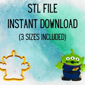 Op de afbeelding: STL-bestandsdownload voor een 3D-printbare koekjesvorm van het alien-personage uit de film Toy Story. De afbeelding toont de koekjesvorm in geel en het alien-personage in groen, blauw en paars.