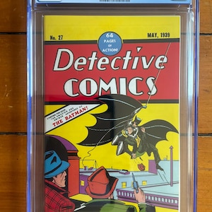 May include: A CGC graded 9.4 Detective Comics No. 27 comic book from May 1939, featuring a yellow cover with the title in red and black. The artwork depicts a character in a black cape swinging above a rooftop, with two figures in the foreground.