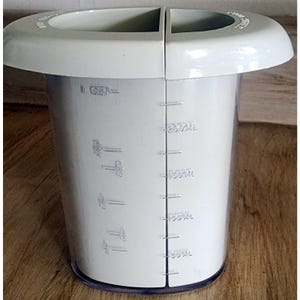 May include: A white plastic measuring jug with a handle and clear markings for measurements. The jug has a capacity of 250ml and is marked with measurements in milliliters. The jug is designed for kitchen use.