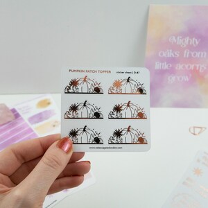 May include: A sheet of six pumpkin patch themed stickers with a copper foil finish. The stickers feature pumpkins, leaves, and flowers. The text "PUMPKIN PATCH TOPPER" and "sticker sheet | D-87" is printed on the sheet.
