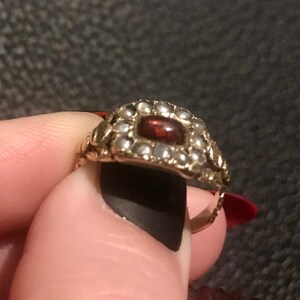 Garnet ring with ornate shoulders