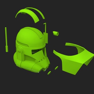 May include: A green plastic model of a Star Wars clone trooper helmet, disassembled into its individual parts.