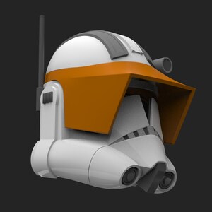 May include: A white and orange clone trooper helmet with a black antenna and a visor. The helmet has a distinctive orange visor and a black stripe on the top.