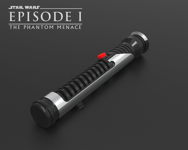 May include: A black and silver lightsaber with a red button. The lightsaber is from the Star Wars Episode I: The Phantom Menace movie.
