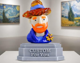 May include: A glass sculpture of Vincent van Gogh with an orange beard and hat, wearing a blue jacket. The sculpture is on a grey base with the text "CUSTOM For You". Two paintings hang in the background.