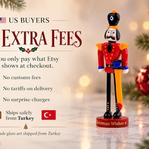 Detail view of the handcrafted glass sword attached to the Nutcracker figure, with vivid orange, yellow, blue, and red glass colors.