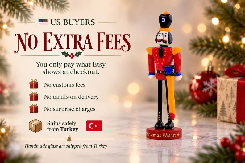 Detail view of the handcrafted glass sword attached to the Nutcracker figure, with vivid orange, yellow, blue, and red glass colors.
