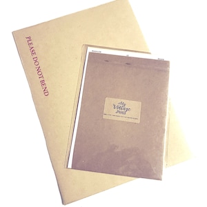 May include: A brown paper envelope with the text "PLEASE DO NOT BEND" printed in red. The envelope is folded and has a smaller brown envelope inside with a sticker that says "My Vintage Prints".