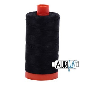 May include: A spool of black thread with a red plastic bobbin. The thread is wound tightly and has a smooth texture. The spool is labelled "Aurifil" in blue lettering.