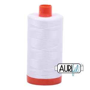 May include: A spool of white thread with a red plastic bobbin and the text "AURIfil" in blue.